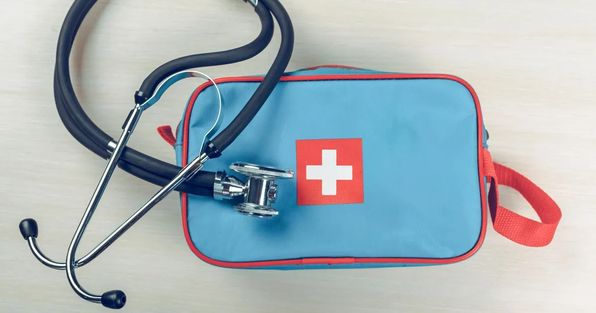 Open first aid kit with organized medical supplies and medications for emergency preparedness