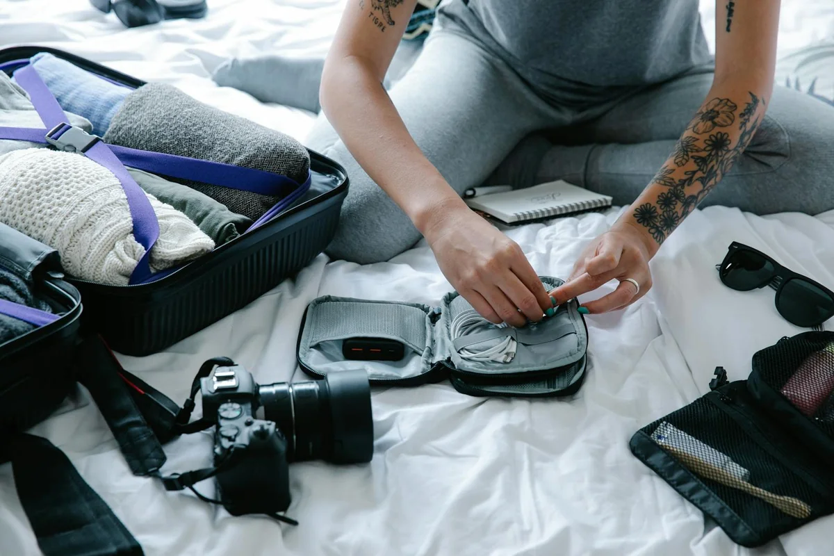 Hands packing a bug-out bag for evacuation