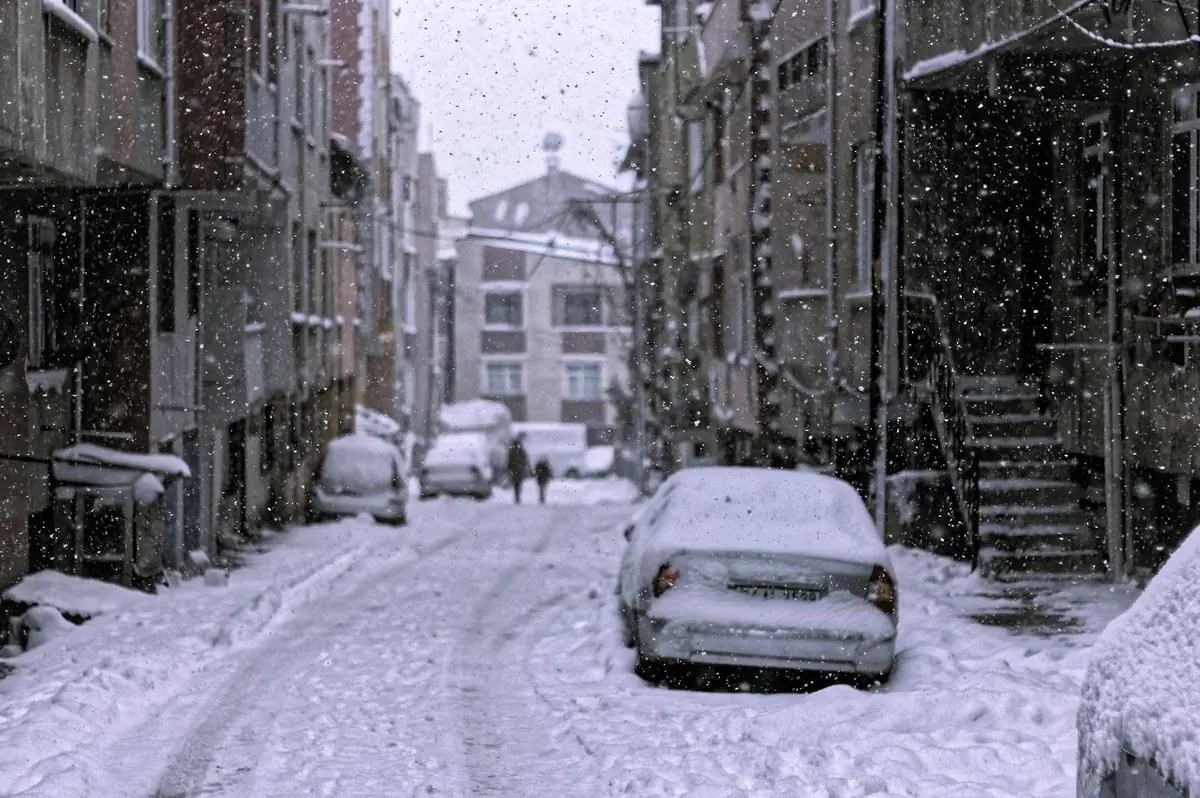 Snowy street with cars during extreme snowfall